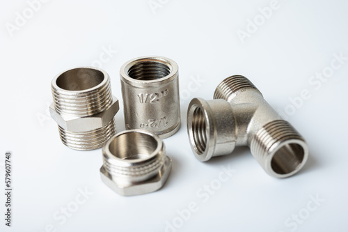 brass metal tee water adapters isolated on light background close up plumbing connections and details