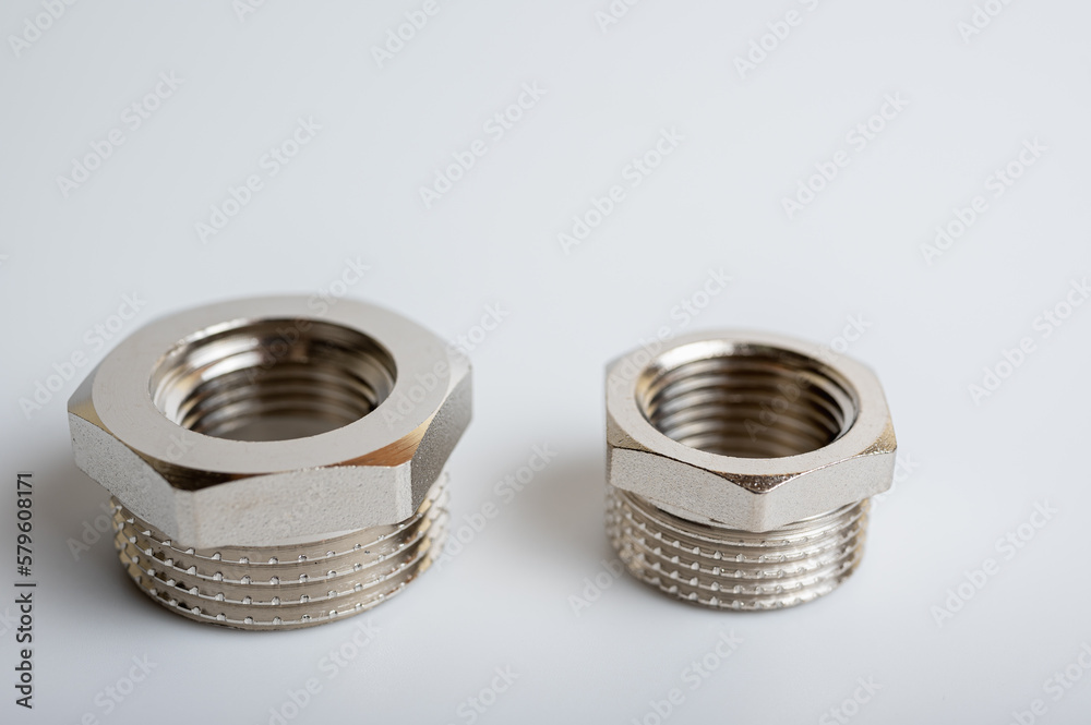 brass metal plugs, joints, adapters, hex key plugs for water isolated on light background close up plumbing connections and parts brass metal plugs, joints, adapters, hex key plugs for water isolated on light background close up plumbing connections and parts