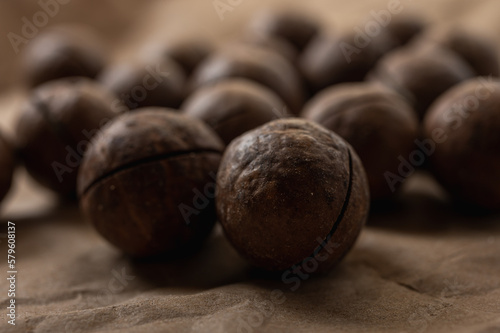 background, macadamia nuts close up view on gray background, tasty nut healthy food. Low key