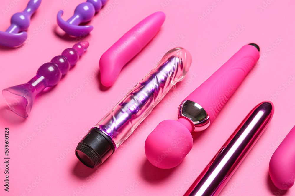 Vibrators with anal plugs on pink background, closeup Vibrators with anal plugs on pink background, closeup