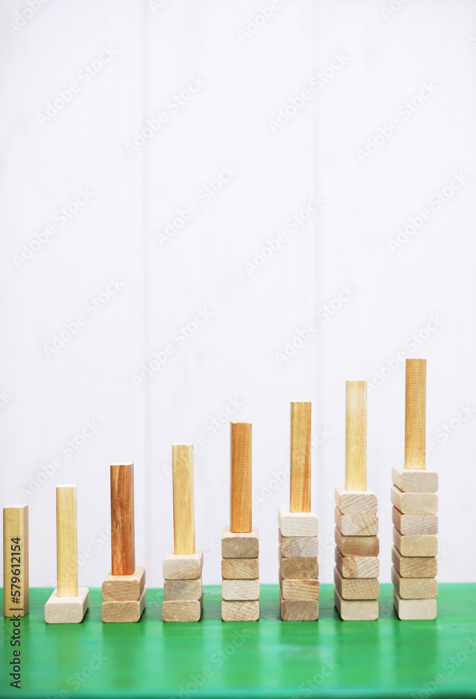 Φωτογραφία Stick wood block standing on stacked square wood blocks, abstract background in concept of winning, success, challenge, step to top position