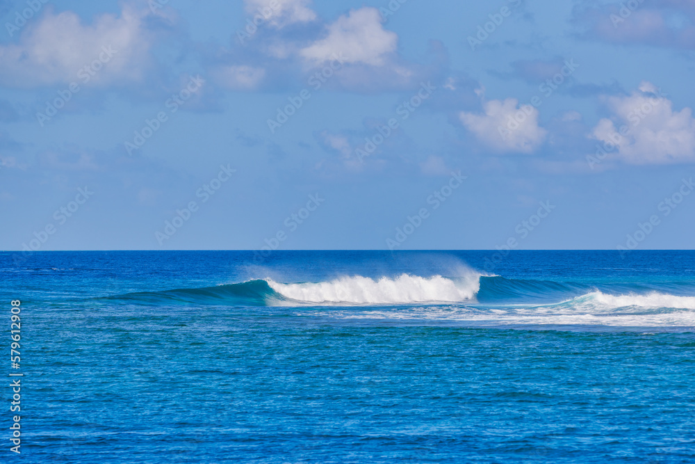 Sunny blue ocean waves. Beautiful panorama of splashing blue wave curl. Nature sea, seascape with horizon under cloudy blue sky. Idyllic ecology environment view