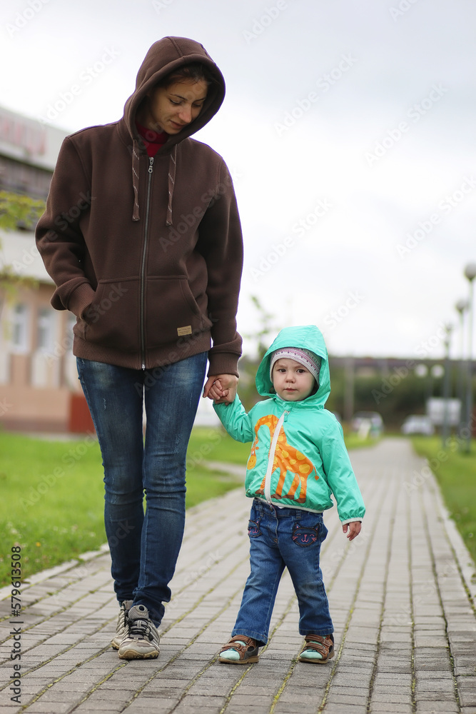 A small child on a walk with mother