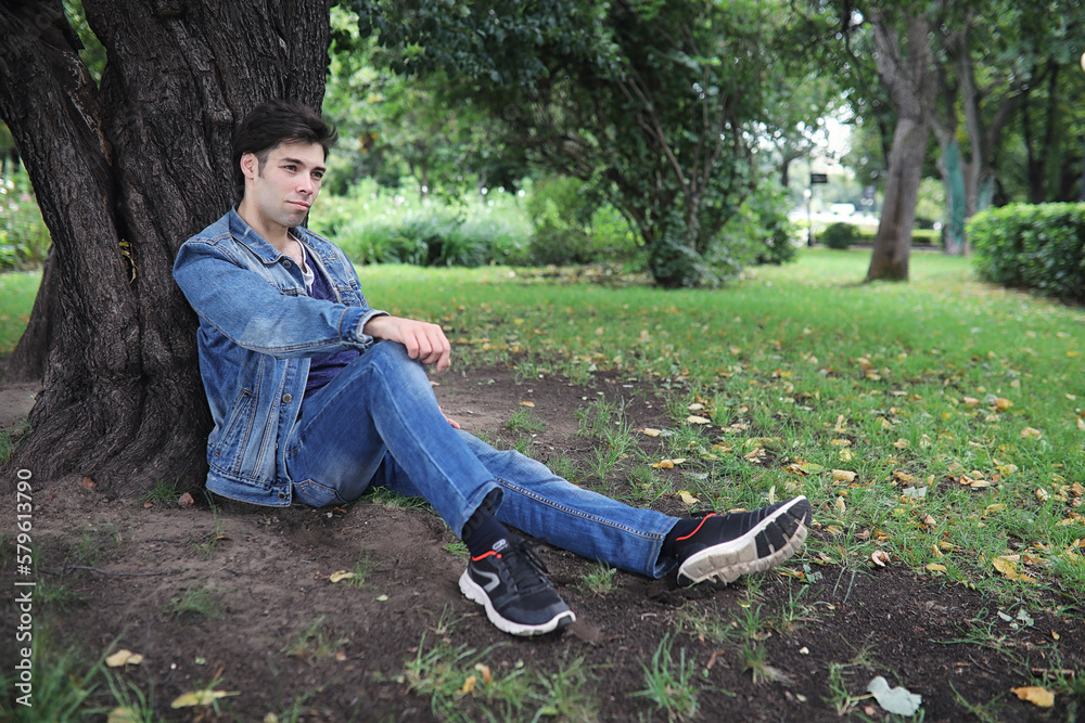 A young man walks in the park at lunch time. A man is on a walk in the city. A student in the park. A young man walks in the park at lunch time. A man is on a walk in the city. A student in the park.