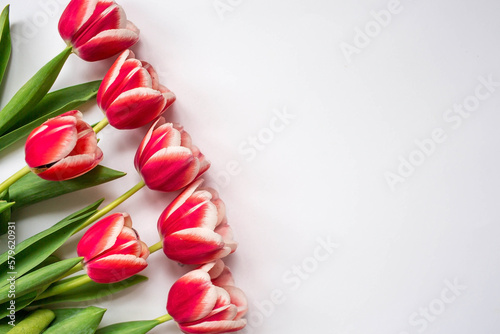 Fototapeta Naklejka Na Ścianę i Meble -  A bouquet of tulips on a white isolated background. The concept of the onset of spring and International Women's Day on March 8.