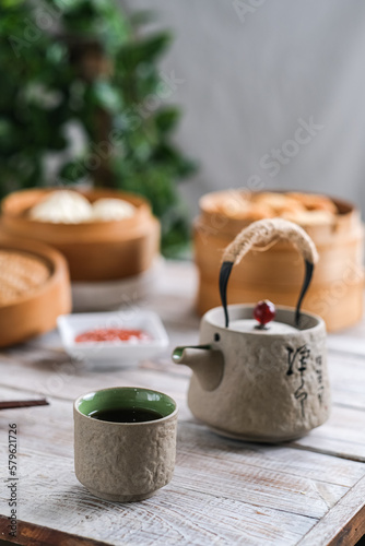 a cup of tea and dim sum on the wooden table