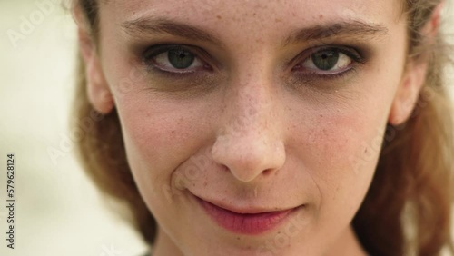 Portrait of crazy caucasian woman with an evil smile, looking at camera