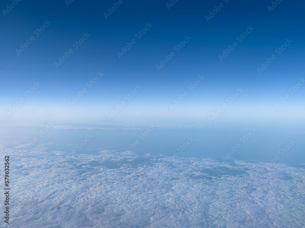 Abstract defocus background. Natural background. Blue sky from above, above the clouds. The backdrop. View from the plane. Soft focus. Copy space
