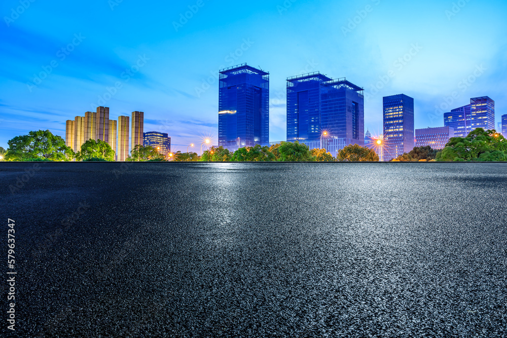 Asphalt road and city skyline with modern buildings at night in Shanghai, China. - obrazy, fototapety, plakaty 