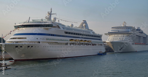 Luxury cruise ship Aura on the Giudecca Canal with tug boats towards the cruise terminal in the port of Venice Venezia with skyline and traffic on waterway  © Tamme