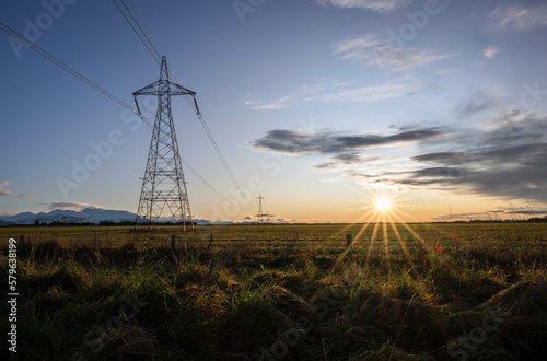 High voltage power pylon towers and powerlines at sunrise, Canterbury, South Island photo