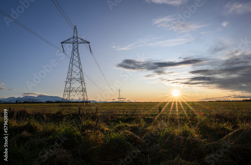 Obraz na płótnie High voltage power pylon towers and powerlines at sunrise, Canterbury, South Island w salonie