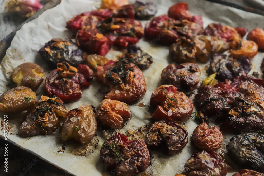colored potatoes baked whole on a baking sheet in crushed form, delicious potatoes colored potatoes baked whole on a baking sheet in crushed form, delicious potatoes