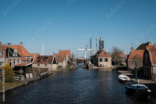 Canal amidst houses against clear sky in town photo