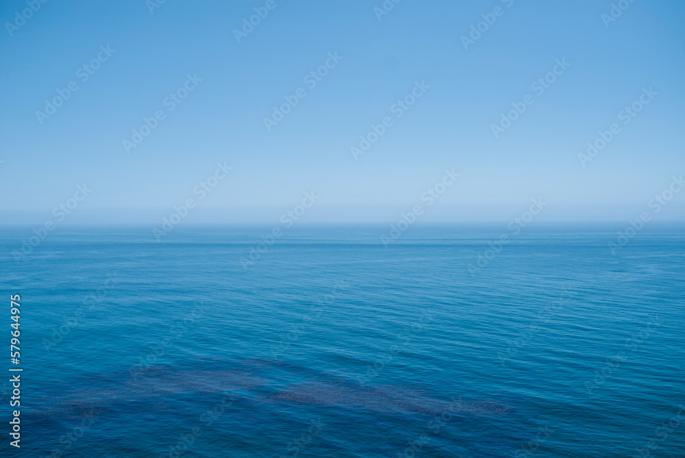 Scenic view of sea against blue sky during summer