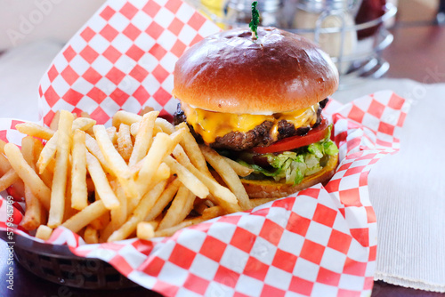 High angle view of burger with French fries served on table in restaurant photo