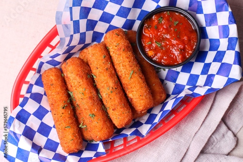 High angle view of cheese sticks with sauce served in plate on table photo