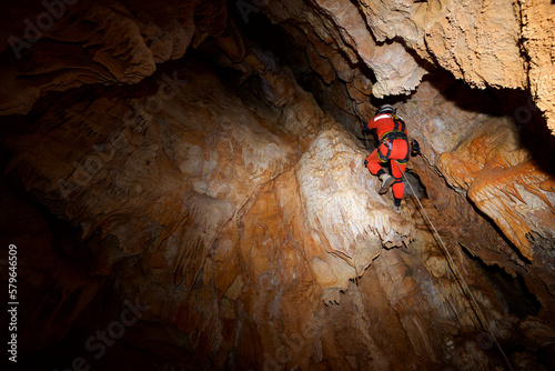 Low angle view of man spelunking in cave