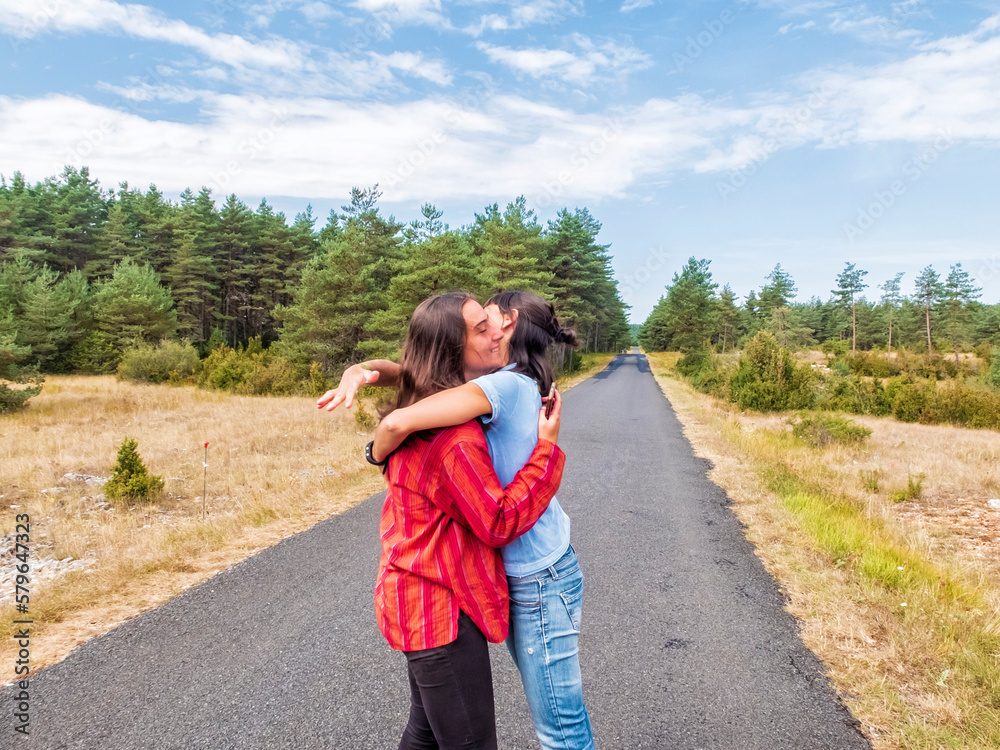 Mom and daughter hugging on an empty road Mom and daughter hugging on an empty road