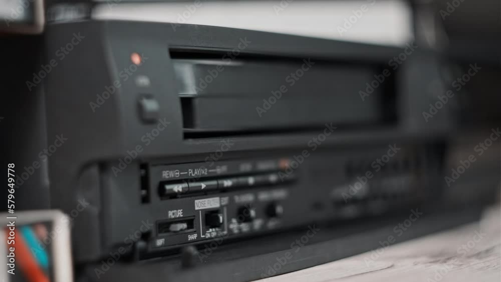 Vidéo Stock Eject VHS tape cassette from VCR player. Male hand pulls