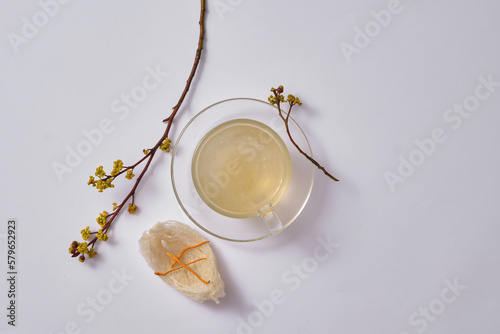 Glass transparent cup of bird’s nest soup arranged with cordyceps (Ophiocordyceps sinensis) placed on edible bird’s nest. Bird’s nest is a supplement for growing children photo