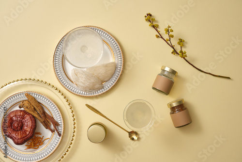 Edible bird’s nest and bird’s nest soup with few empty label glass jars and a dish of herbs. Bird's nest and herbs are very popular in Korea and China, traditional medicine photo