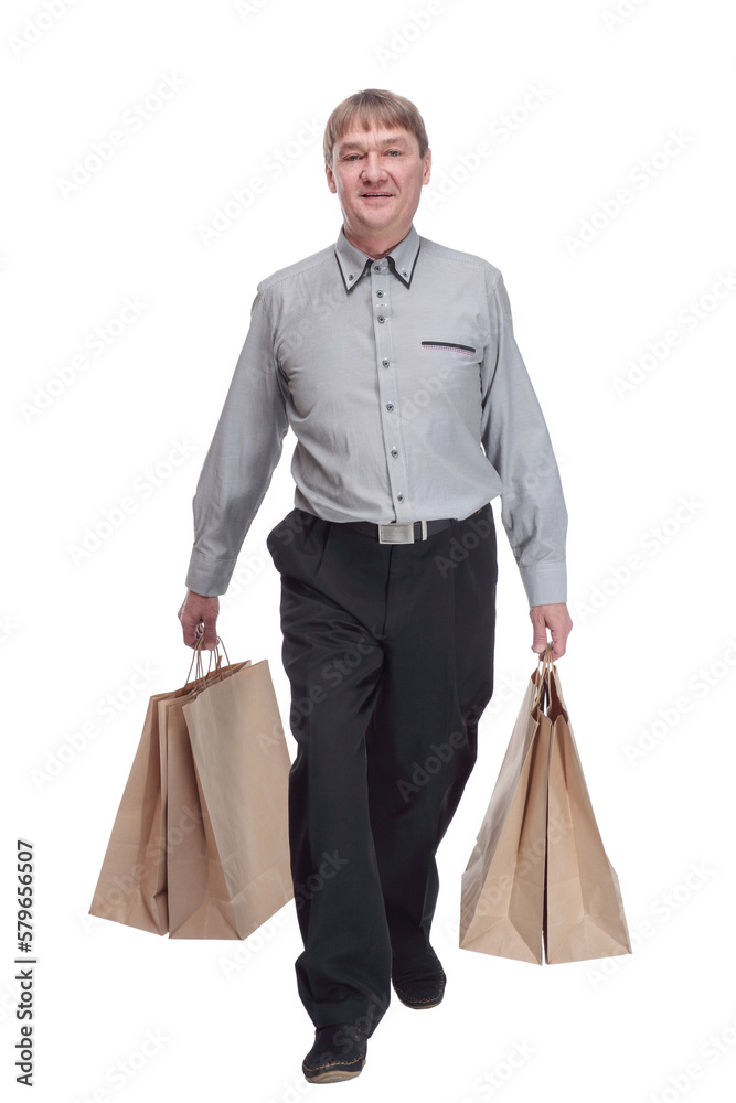 satisfied man with shopping bags striding forward. satisfied man with shopping bags striding forward.
