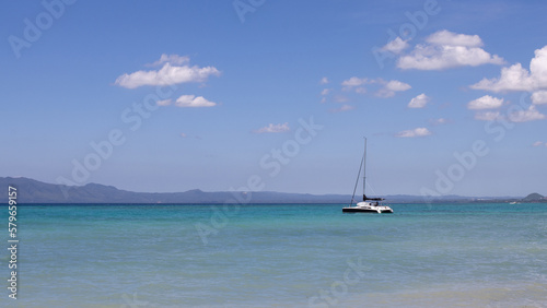 beautiful sea view, with turquoise water and clear, blue sky, a lonely yacht in the sea