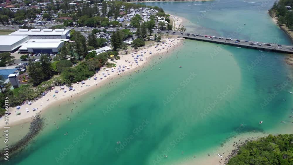 Tallebudgera Creek Bridge Spanning Across Blue Waters With People Enjoying Sun And Sand At The
