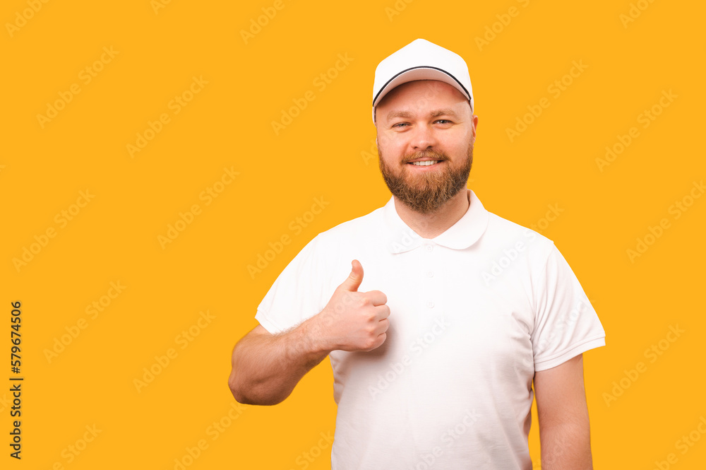 Cheerful strong delivery man wearing white uniform is showing thumb up.