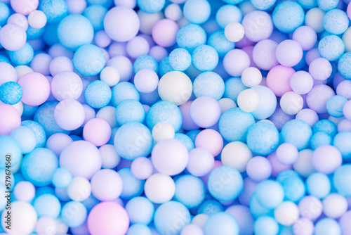Colorful balls background in pink and blue colors. Background with colorful balls in different sizes. Sphere of balls on pastel color.