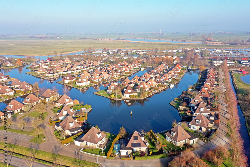 Aerial from a typical dutch landscape: houses and water in Friesland the Netherlands