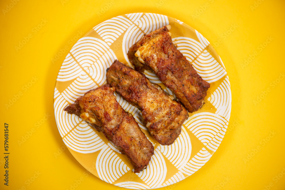 barbecue pork ribs on a plate on a bright background barbecue pork ribs on a plate on a bright background