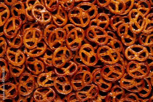 Mini pretzels background textured pattern. Backdrop filled with Baked twists