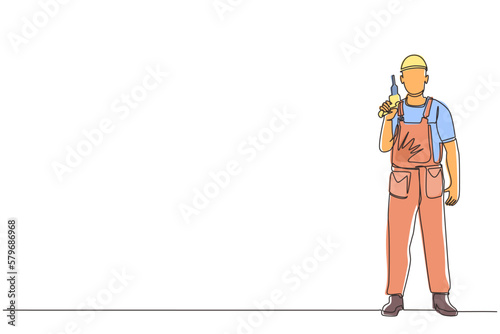 Single continuous line drawing man worker holding electric drill tool for repair. Builder in uniform. Handyman in overalls. Repairman with instrument. One line draw graphic design vector illustration