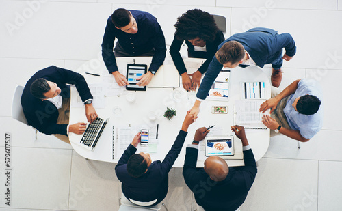 Opening more doors with successful business deals. High angle shot of a businessman and businesswoman shaking hands during a meeting in a modern office.