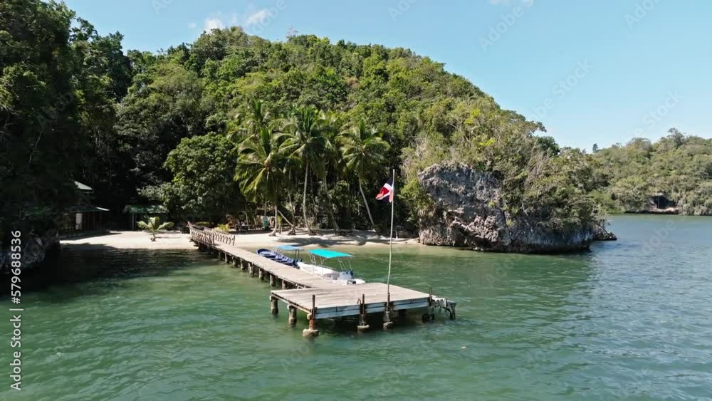 Aerial orbit shot of San Lorenzo Bay with wooden boardwalk and parking boats in Los Haitises National Park