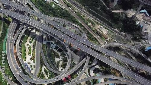 Aerial shot of circular roads and highways floating five levels exchange in Chongqing and cars driving on them, Huangjuewan exchange. Long shot.  photo