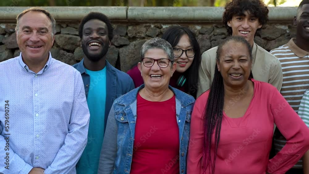 Happy multi generational people smiling on camera at city park - Concept of multiracial friendship Happy multi generational people smiling on camera at city park - Concept of multiracial friendship