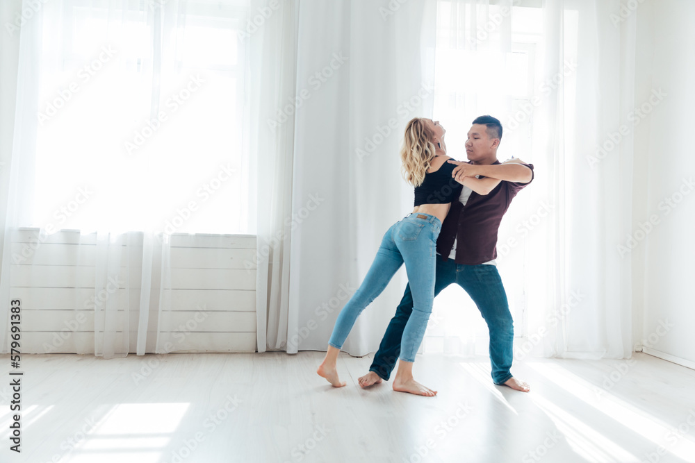 a man and a woman dance in the hall of the latin bachata studio