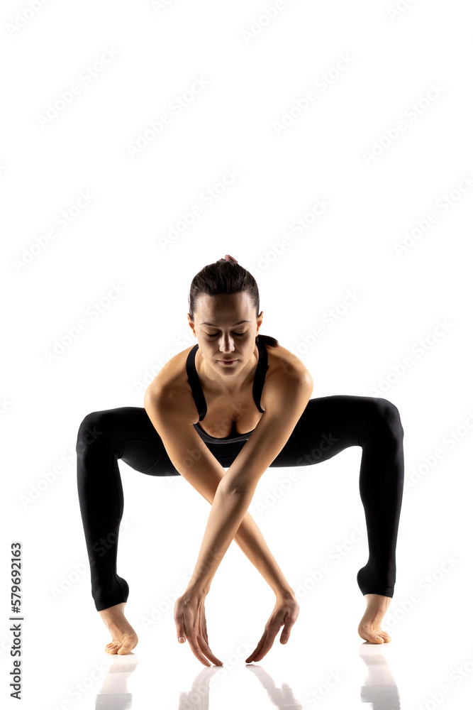 Portrait of young beautiful woman in black sportswear doing yoga practice. Portrait of young beautiful woman in black sportswear doing yoga practice.
