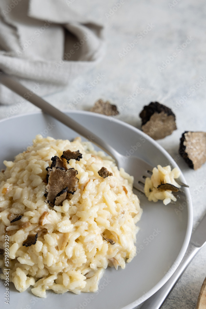 Risotto with porcini mushrooms and black truffles served in a plate top view, gourmet cousine Risotto with porcini mushrooms and black truffles served in a plate top view, gourmet cousine