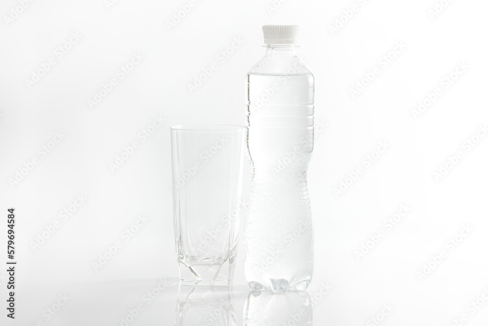 Empty glass and water bottle on white background Empty glass and water bottle on white background