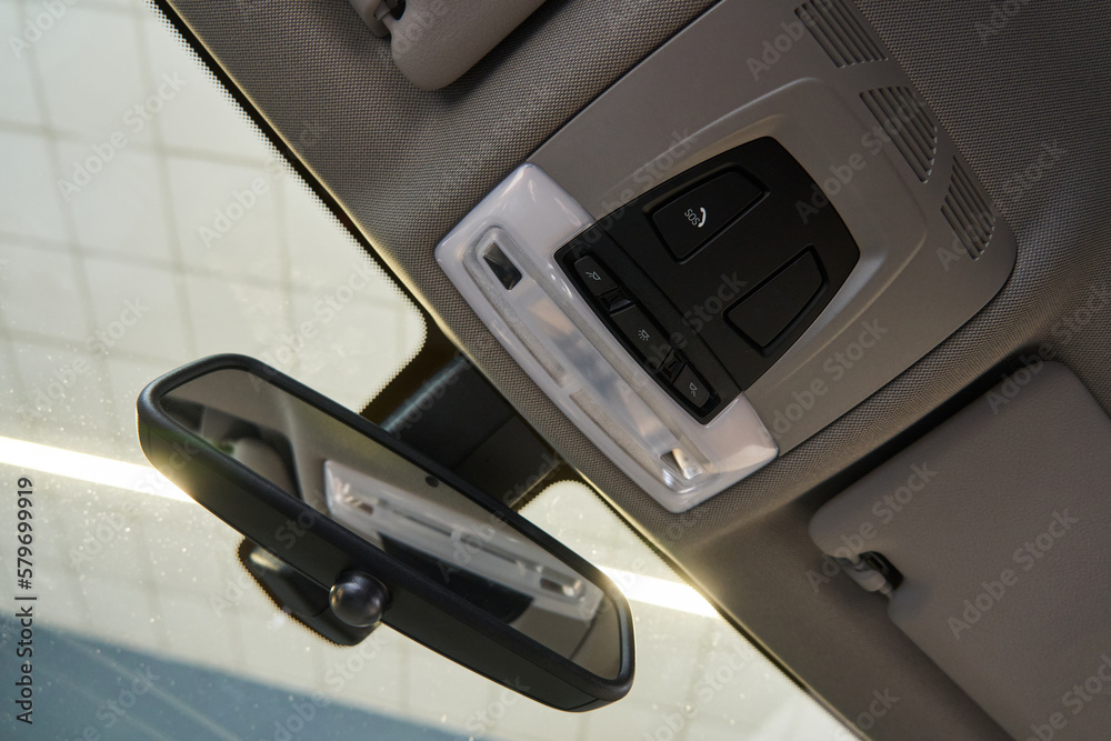 interior rear-view mirror of the car, SOS button and ceiling lights with power buttons on the ceiling interior rear-view mirror of the car, SOS button and ceiling lights with power buttons on the ceiling