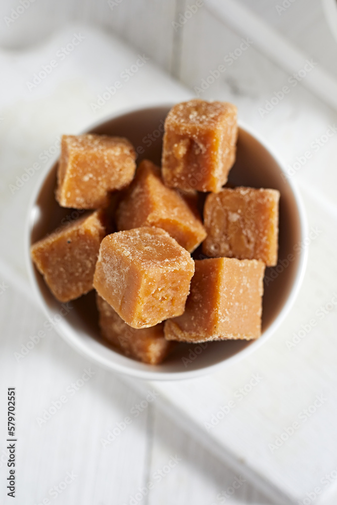 Close up brown cane sugar on white background