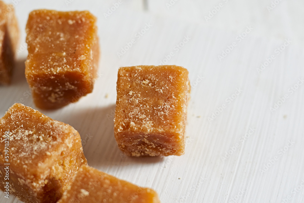 Close up brown cane sugar on white background Close up brown cane sugar on white background