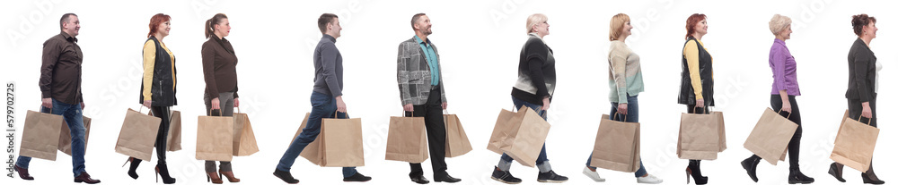 a group of people are running paper shopping bags