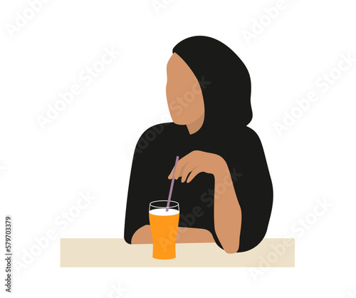 Muslim or arab woman sitting drinking orange juice