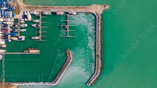 Top down view over a boat port in Balaton lake, Hungary. Top view of  Yacht club. Drone view. Sail boats dock. Green lake. © Skatty