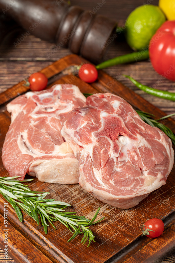 Lamb neck meat. Uncooked raw lamb neck on a wooden serving board. Close up Lamb neck meat. Uncooked raw lamb neck on a wooden serving board. Close up